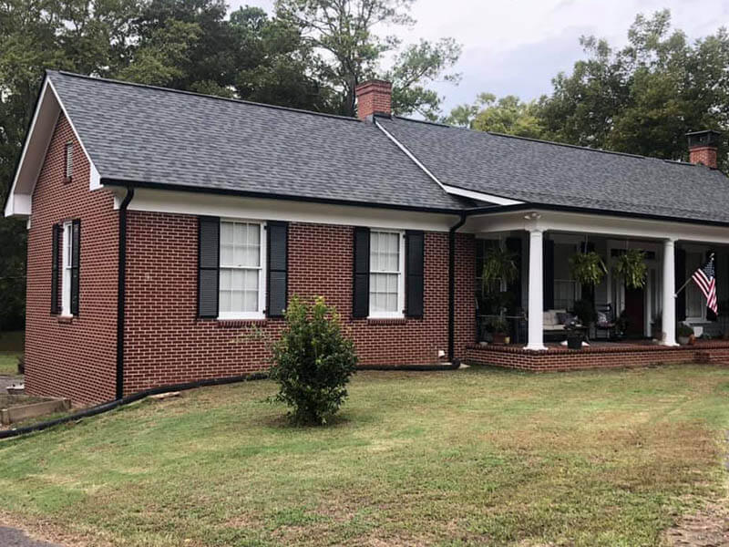 Two-story home exterior with freshly cleaned gutters and downspouts