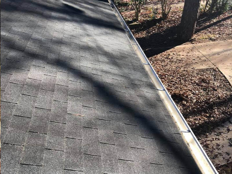 Roof gutter after cleaning — spotless roofline and clear gutters on Atlanta home