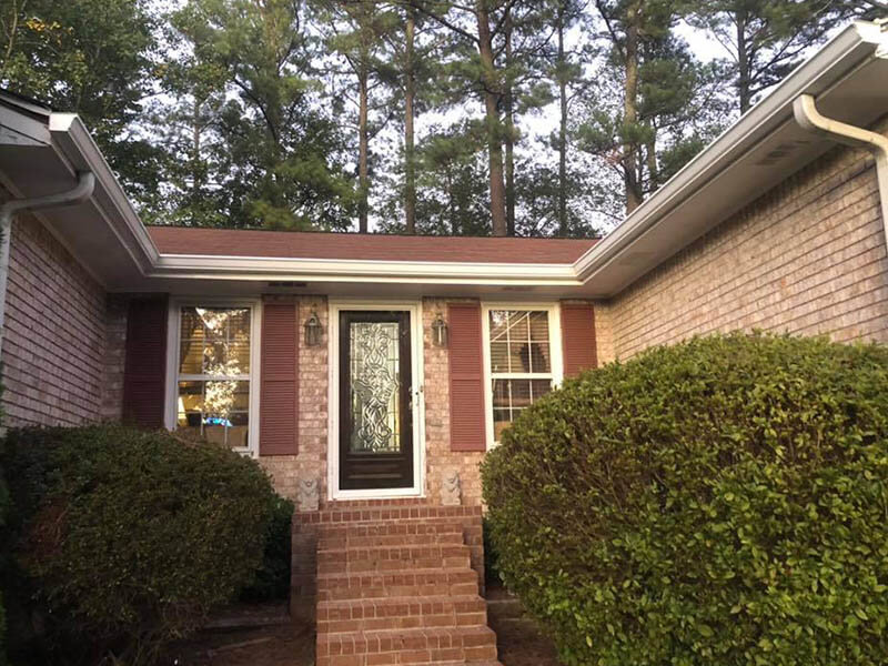 After photo — new clean white gutters installed on Atlanta brick home